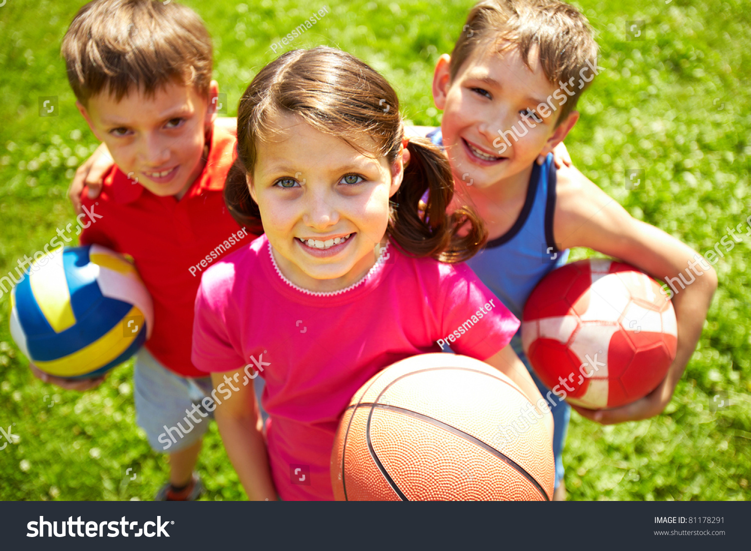 Portrait of three little children with balls looking at camera and smiling #81178291