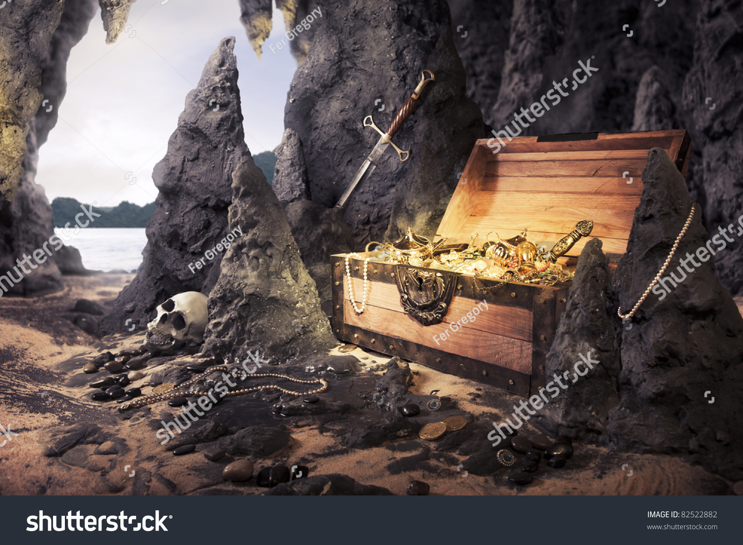 photo of open treasure chest with shinny gold in a cave #82522882