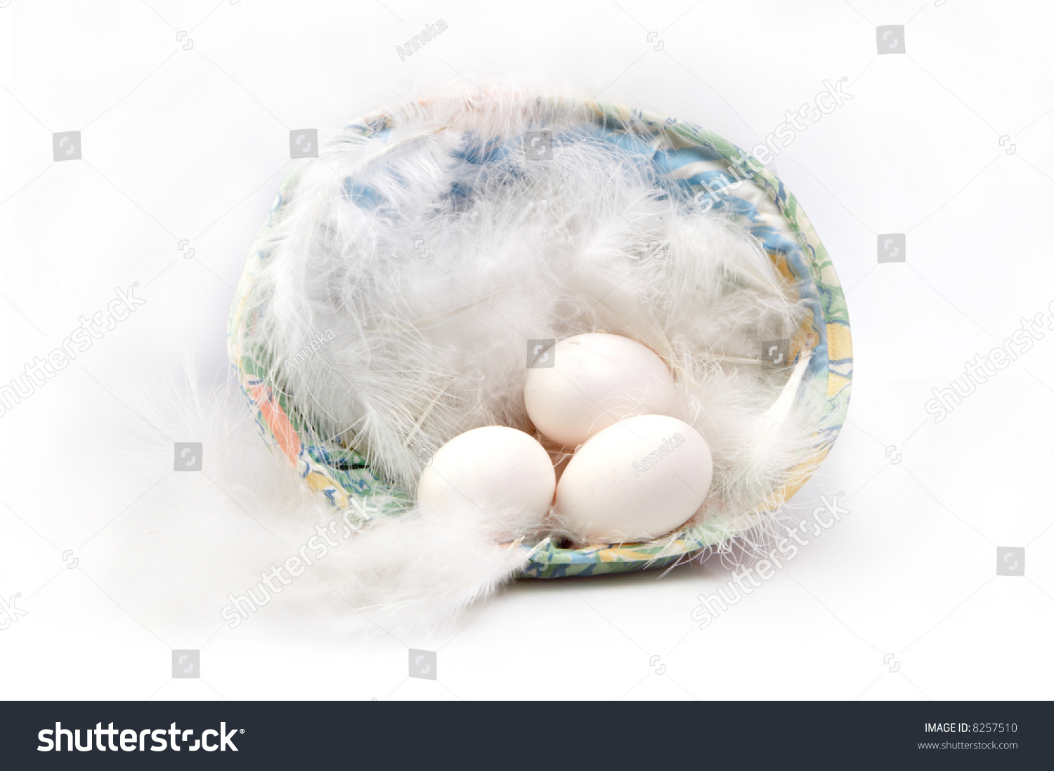 Feathers and three white chicken eggs in an easter basket #8257510