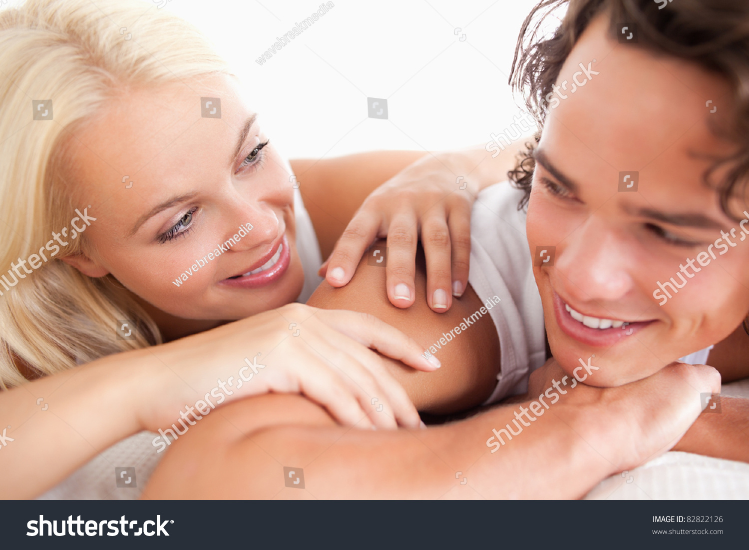 Laughing couple lying while looking at each other #82822126