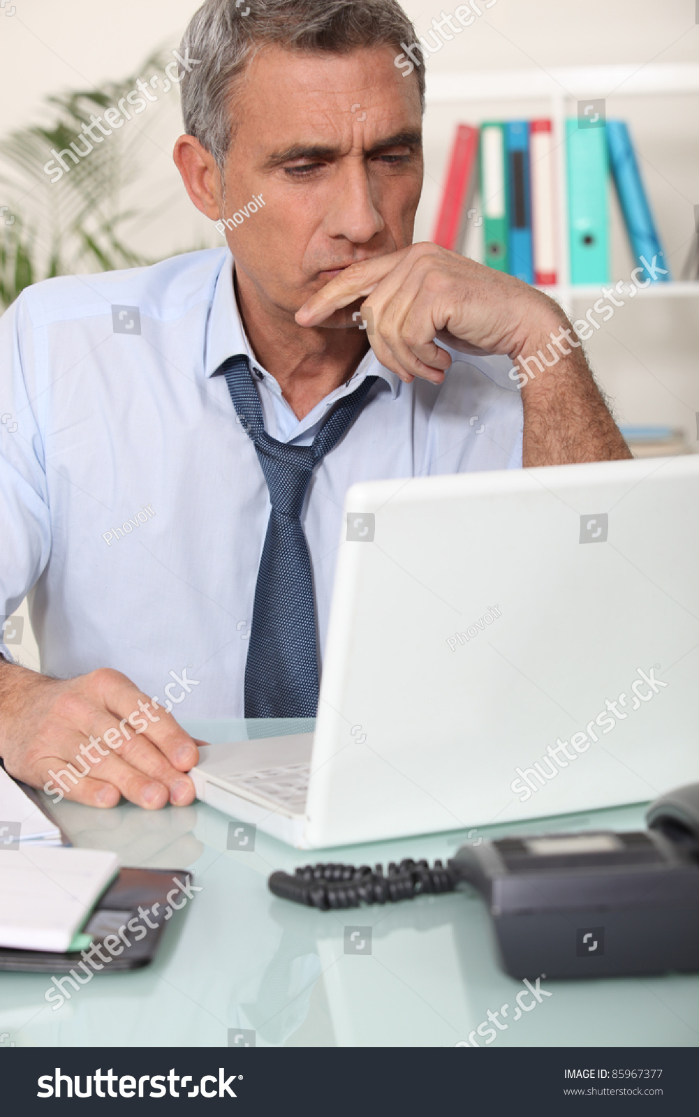 Grouchy man reading an email #85967377