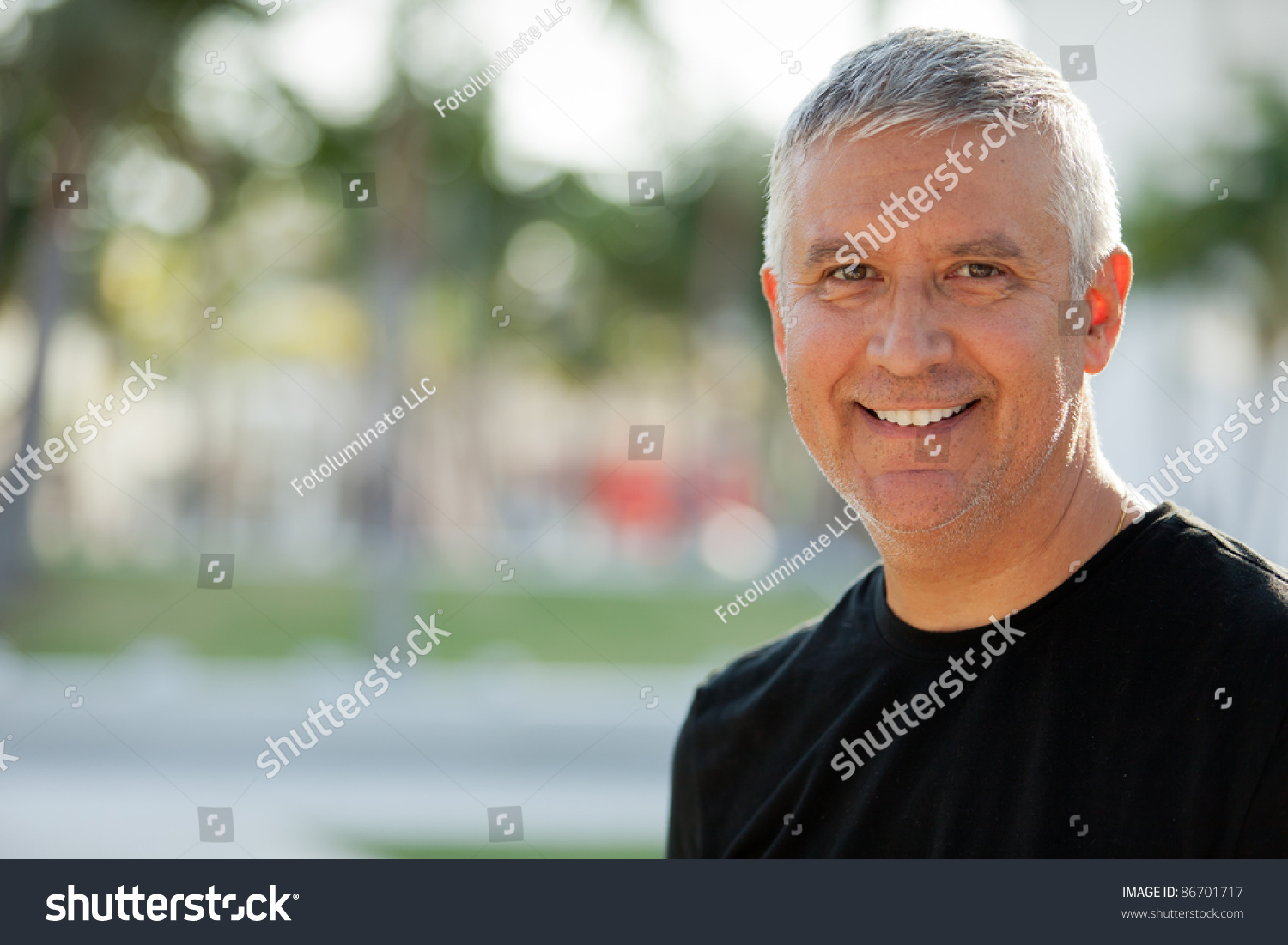 Handsome unshaven middle age man in an outdoor setting. #86701717