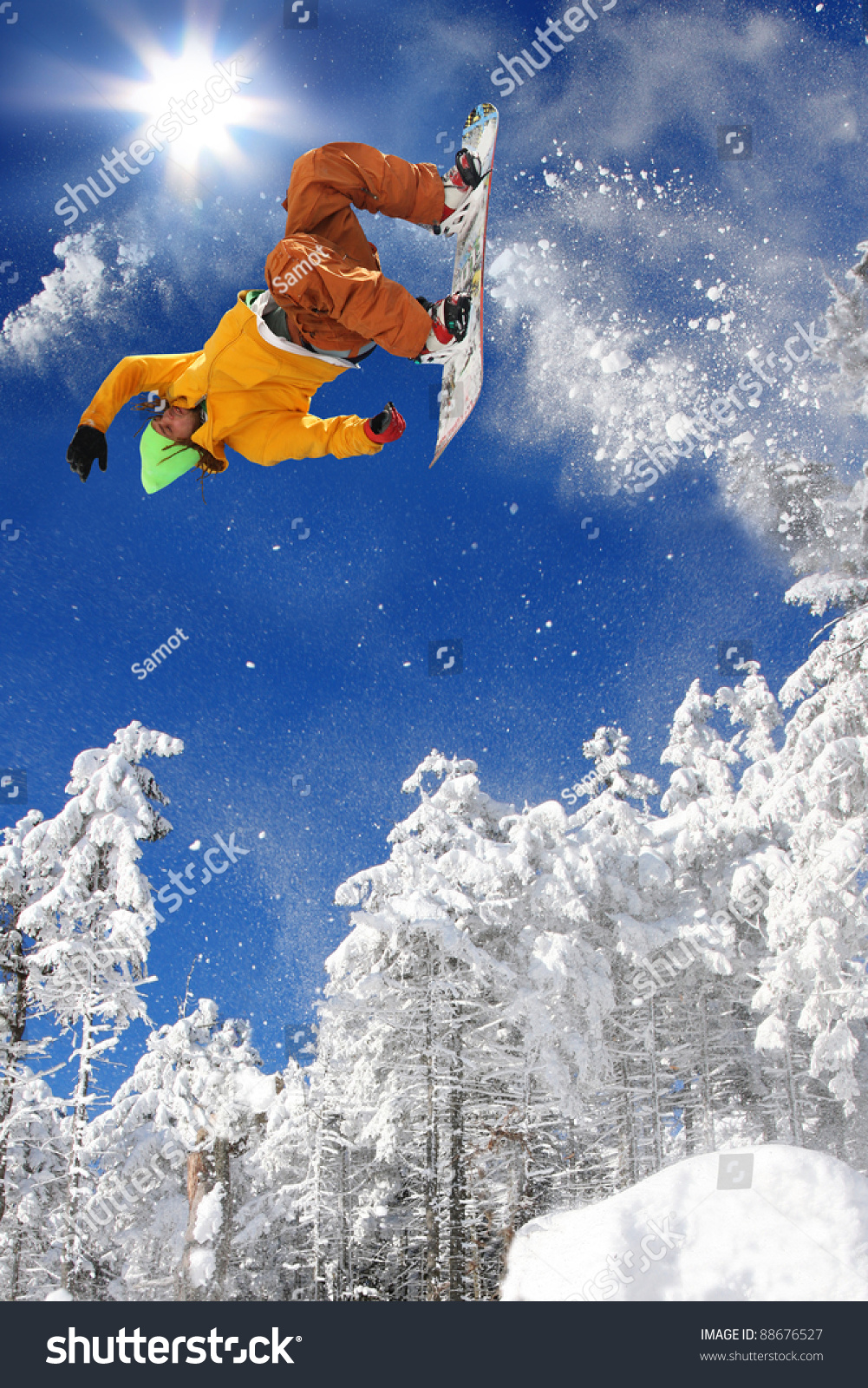 Snowboarder jumping against blue sky #88676527