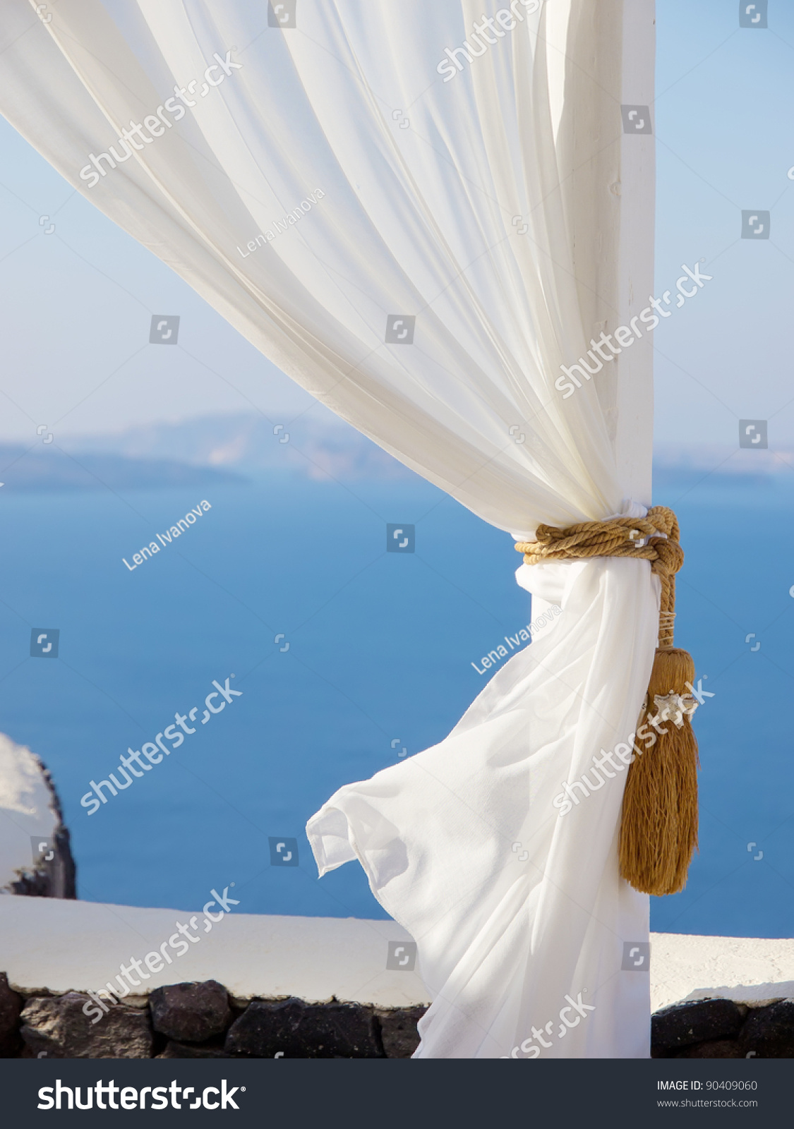 White curtain, detail of white tent on a sea background. Beautiful view of Santorini, Greece. Best luxury resort place for relax and vacations #90409060