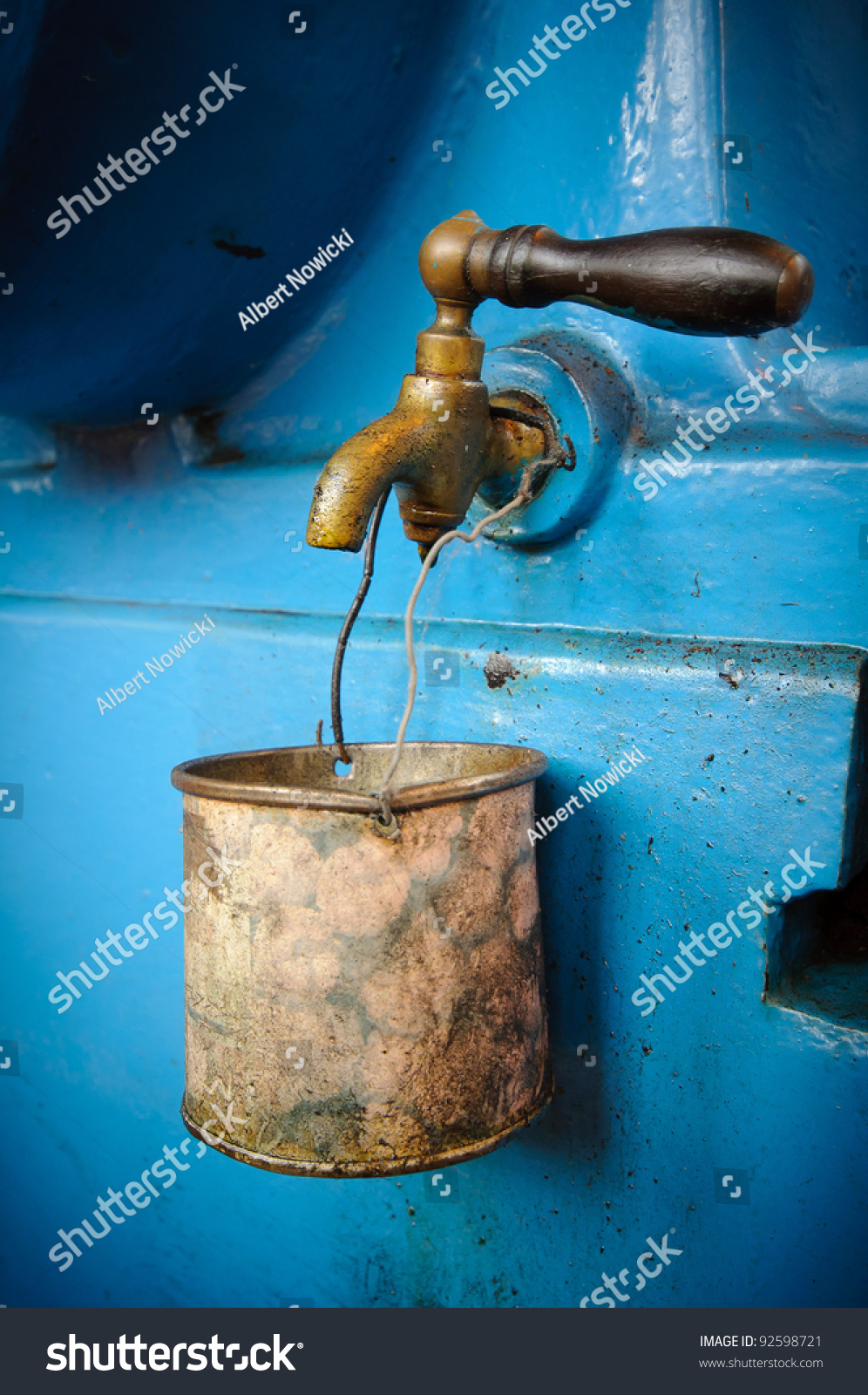 Old tap with rusty mug - water supply shortage #92598721