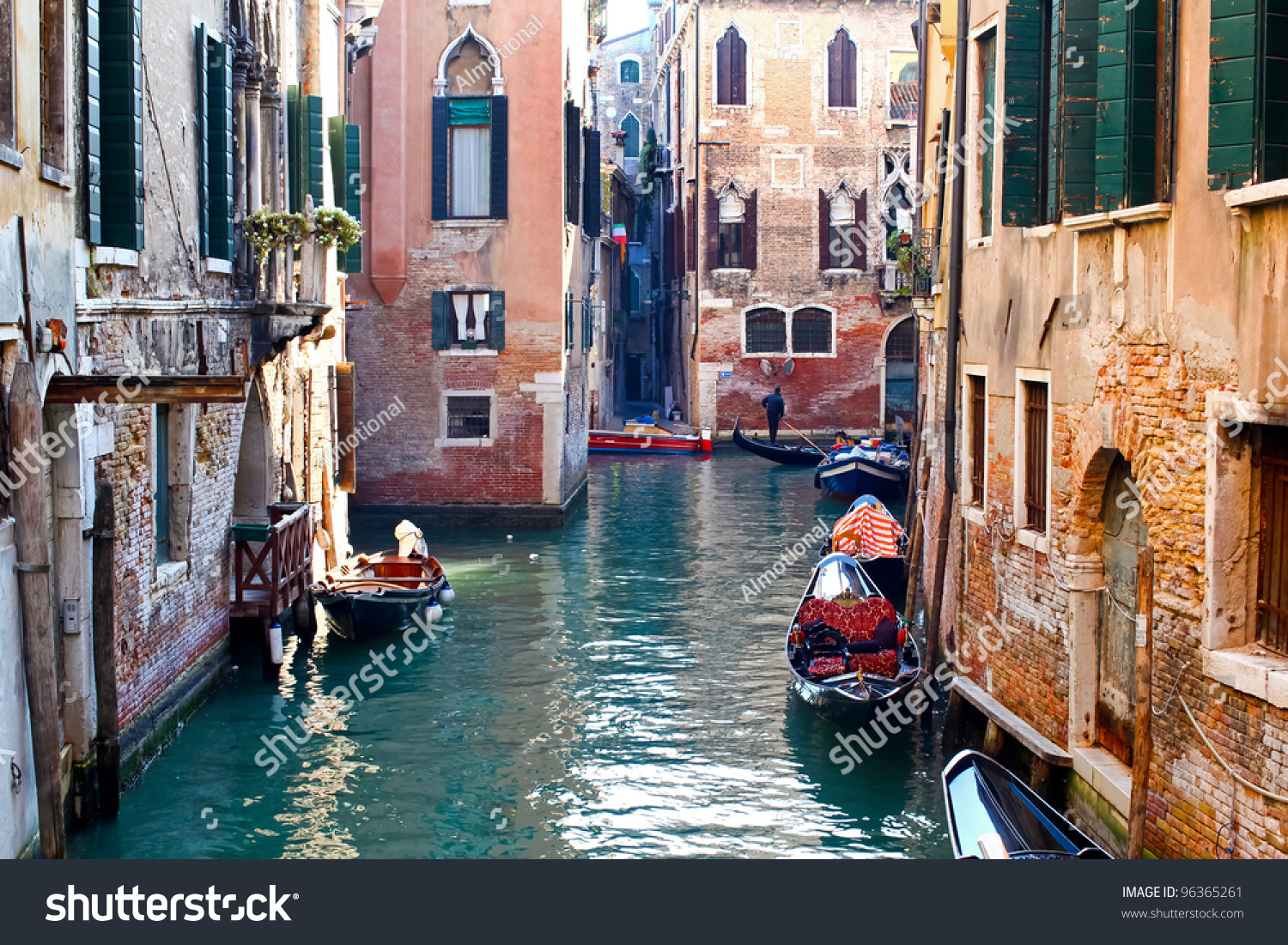 Beautiful colorful canal in Venice with parked gondolas near traditional architecture, Italy #96365261