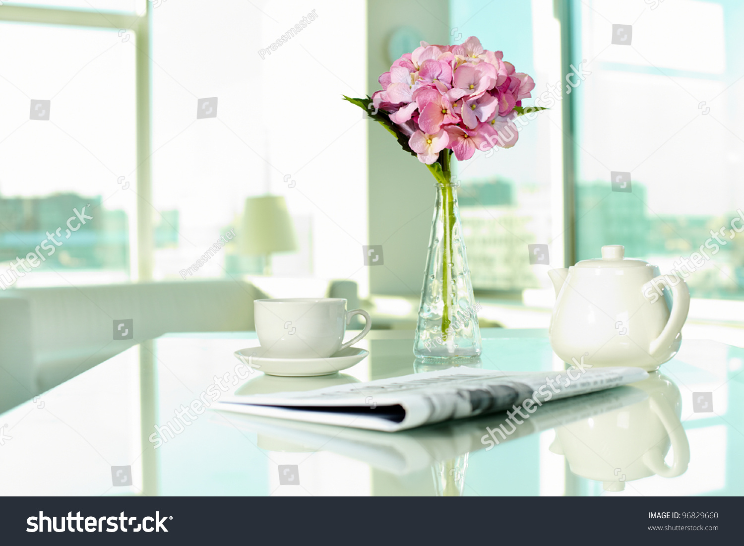 Workplace with porcelain cup and pot, newspaper and bunch of flowers #96829660