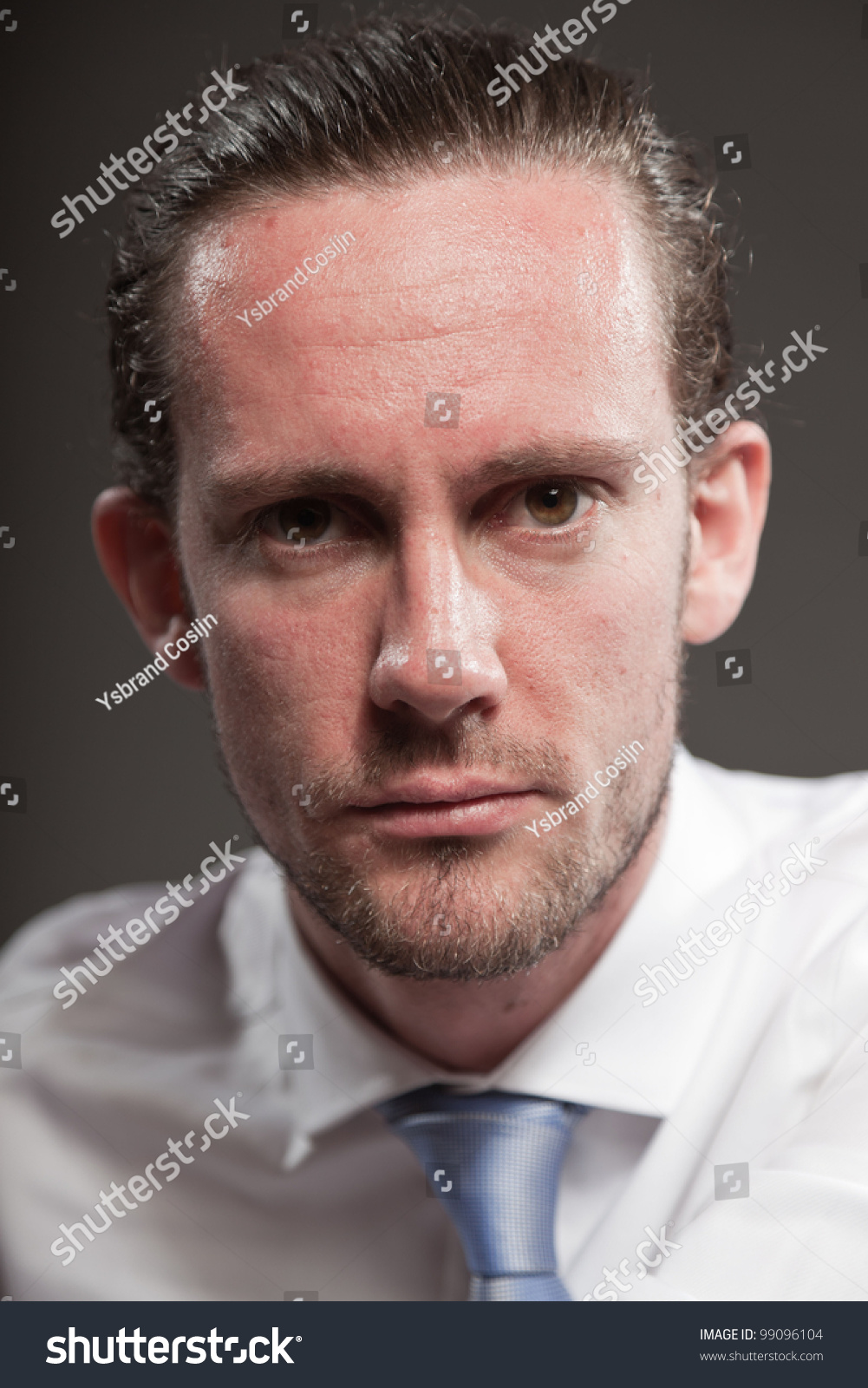 Young man brown hair wearing white shirt and blue tie showing emotions. Isolated on grey background. #99096104