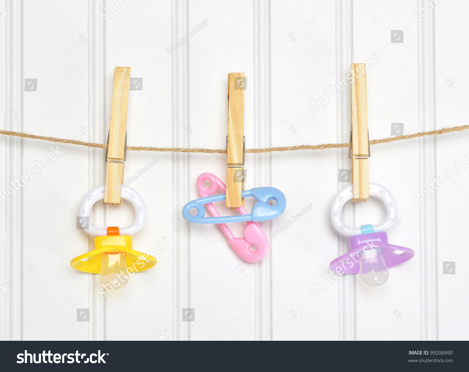 Baby Pacifier Binky Pink on a Clothesline on White. #99206990
