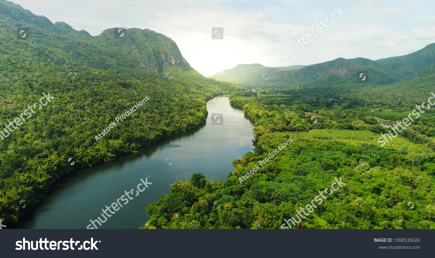 Beautiful natural scenery of river in southeast Asia tropical green forest  with mountains in background, aerial view drone shot #1008530026