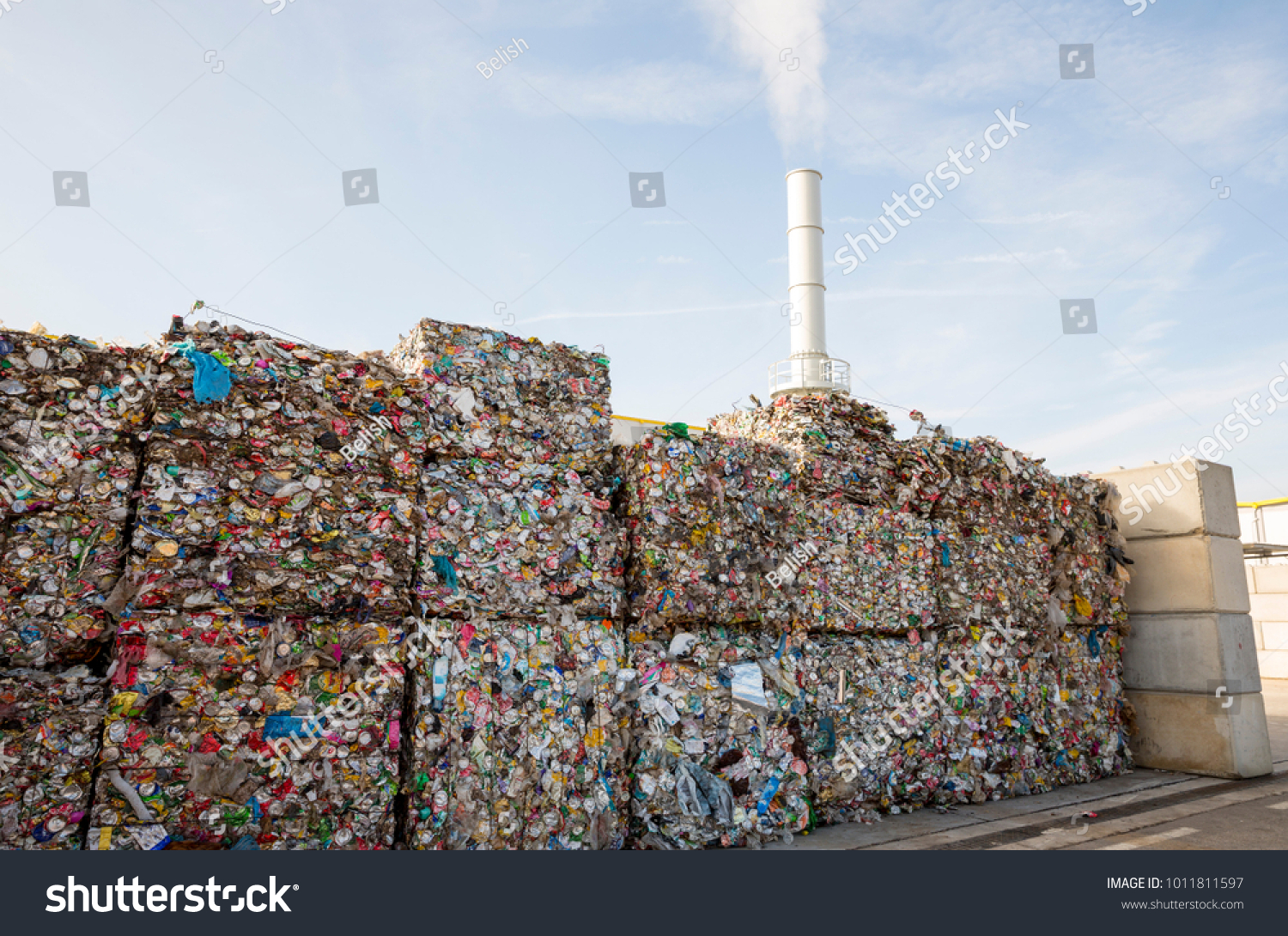 Waste-to-energy or energy-from-waste is the process of generating energy in the form of electricity or heat from the primary treatment of waste. Cubes of pressed metal beer and soda cans. #1011811597