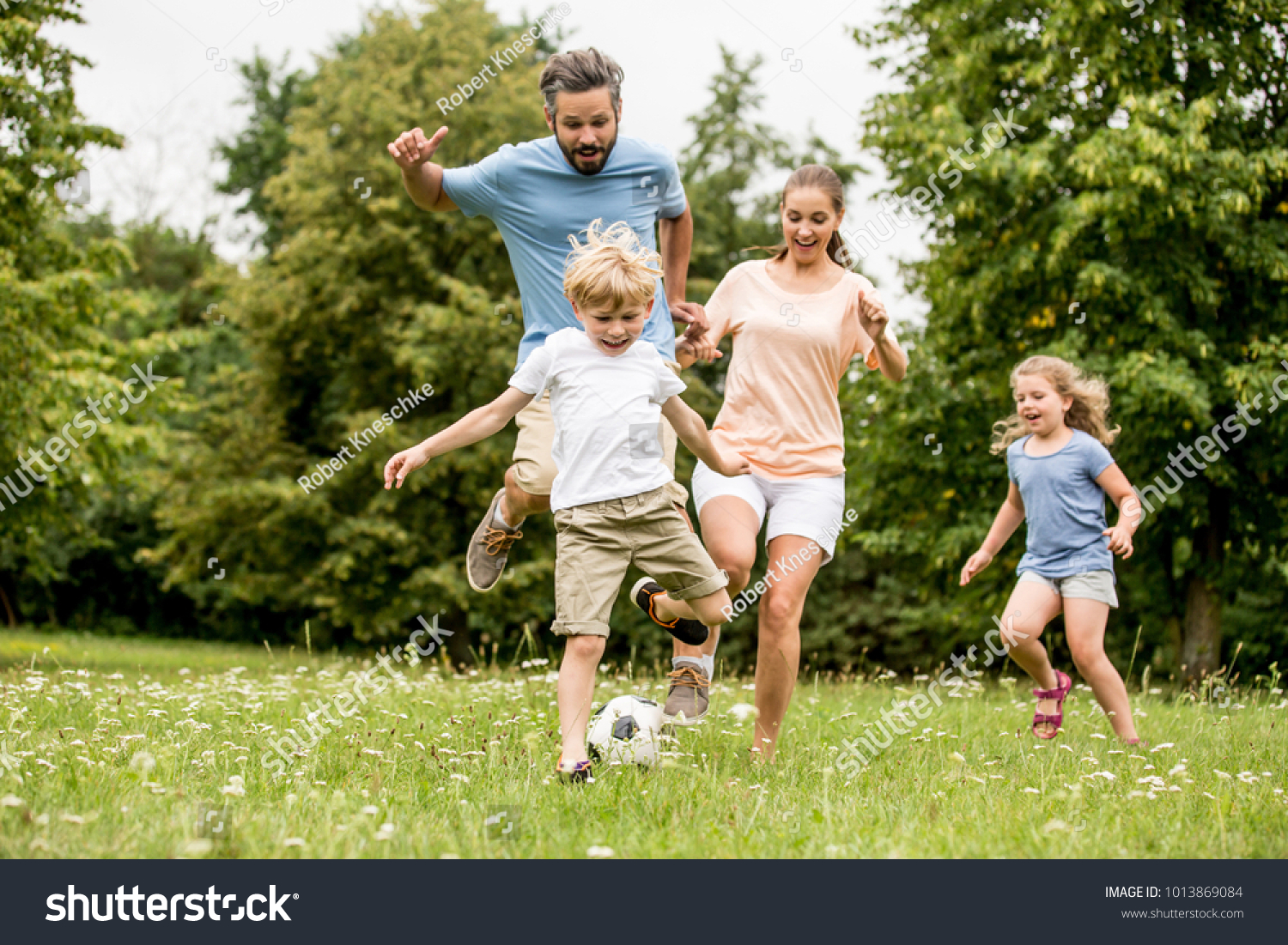 Active family play soccer in their leisure time #1013869084