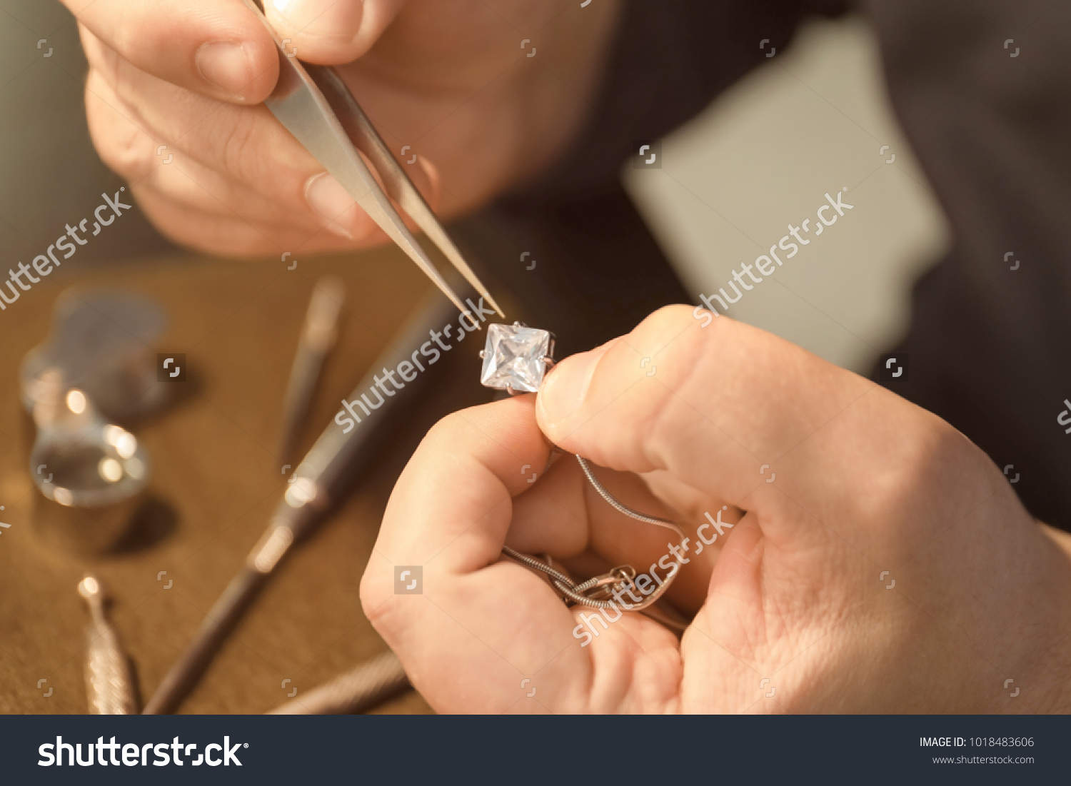 Jeweler working in workshop, closeup #1018483606