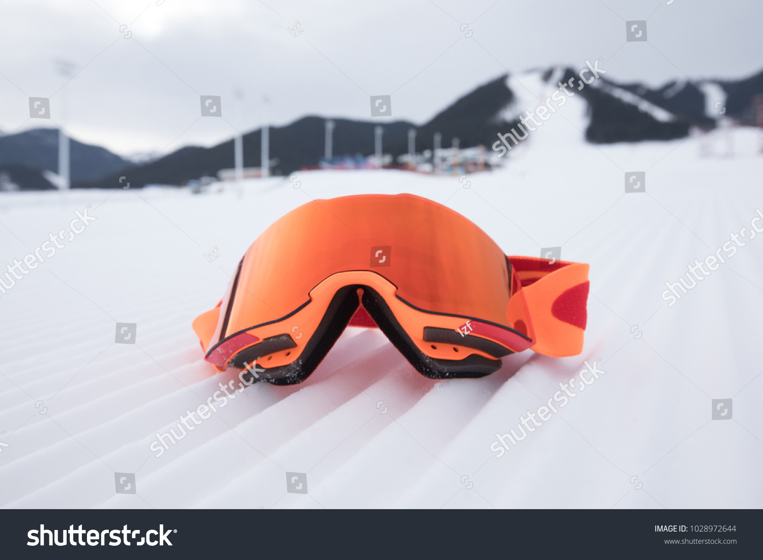 snowboard goggles on ski piste slop #1028972644