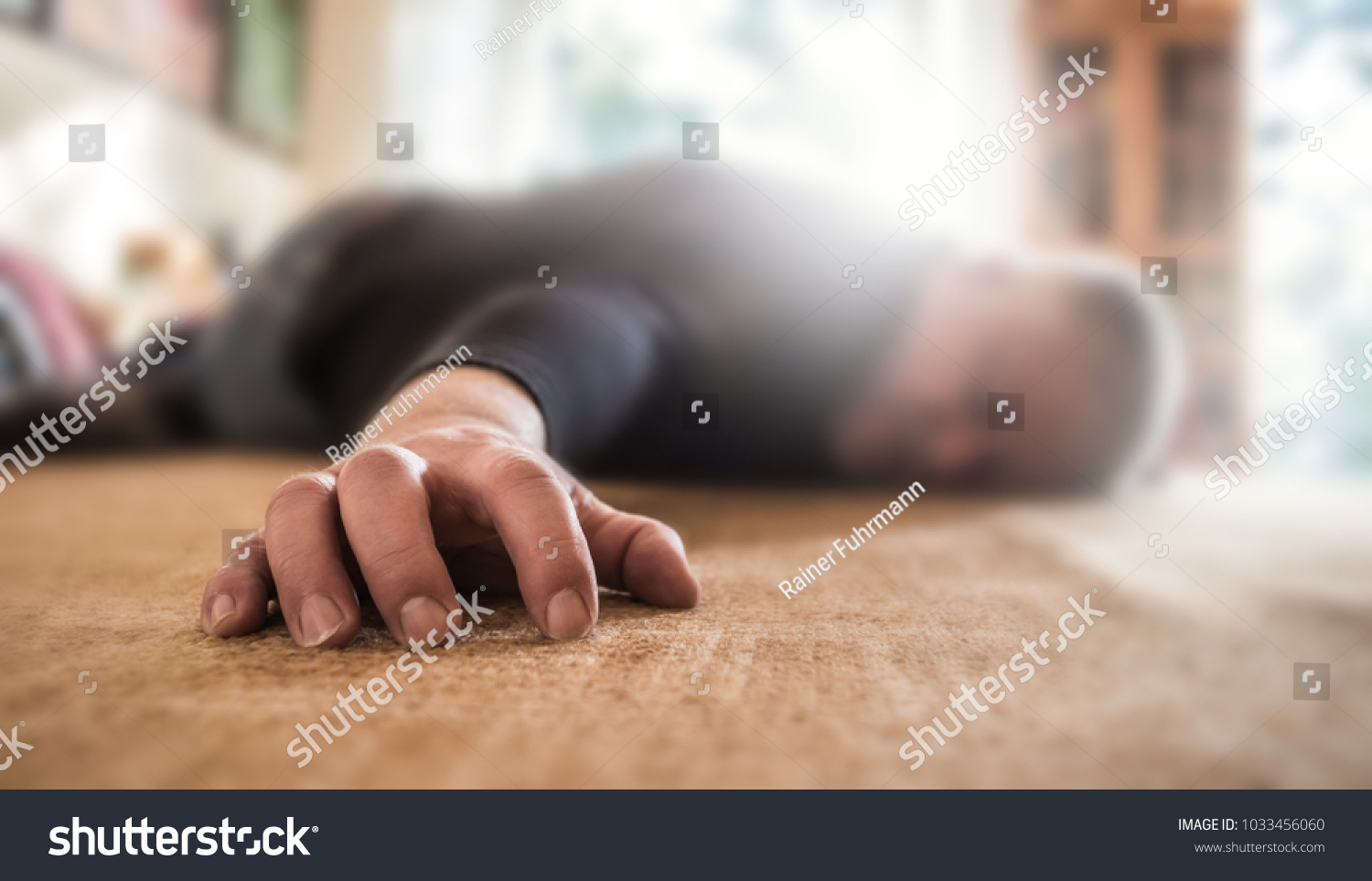 a man lies unconscious in his apartment #1033456060