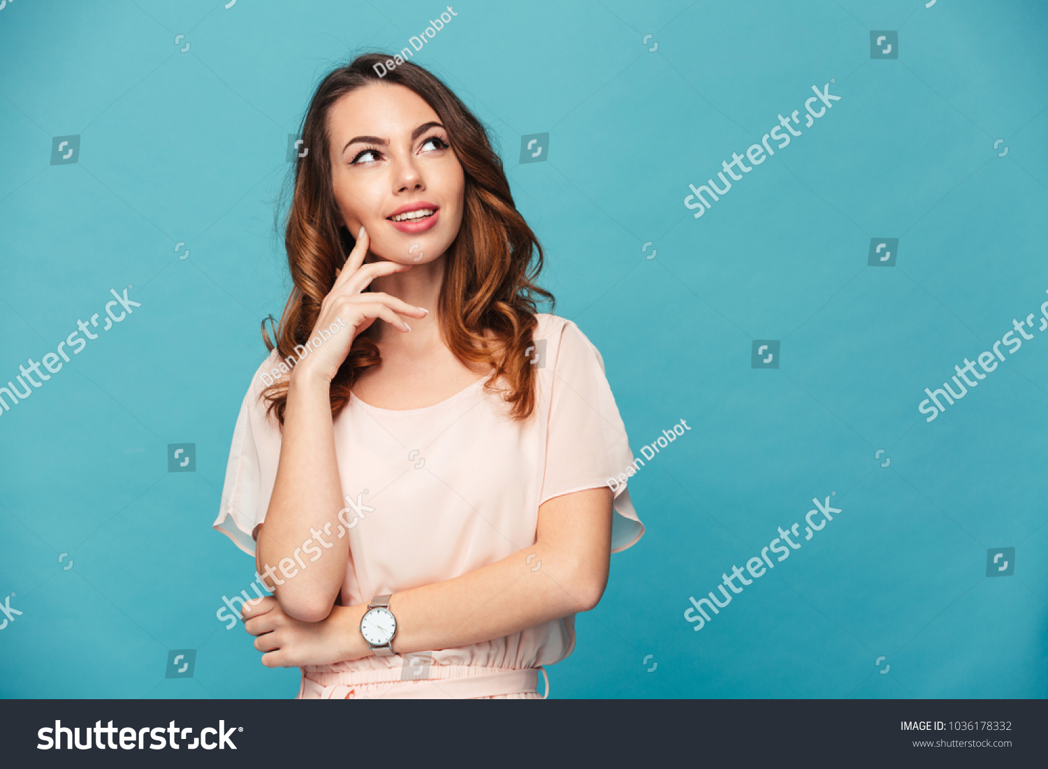 Image of thinking young lady standing isolated over blue background. Looking aside. #1036178332