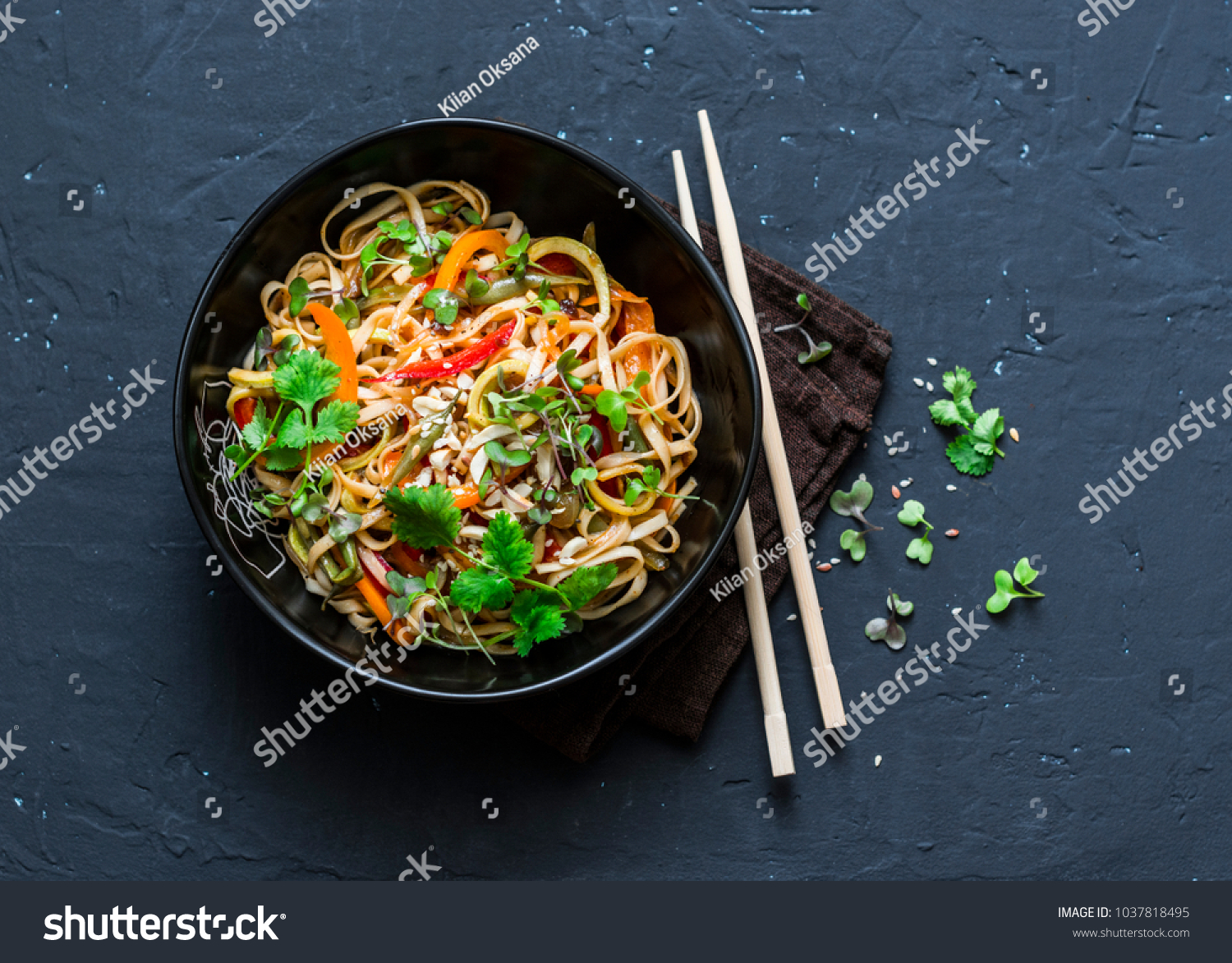Pad Thai vegetarian vegetables udon noodles in a dark background, top view. Vegetarian food in asian style. Copy space  #1037818495