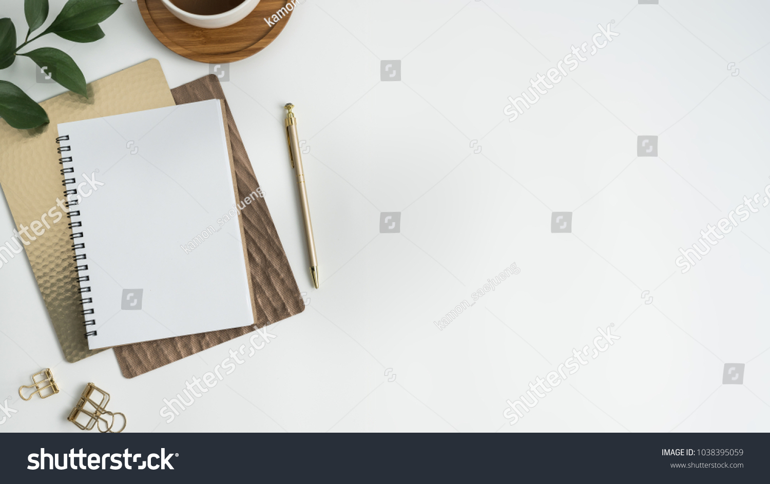 Flat lay, top view office table desk. Workspace with blank clip board, keyboard, office supplies, pencil, green leaf, and coffee cup on white background. #1038395059