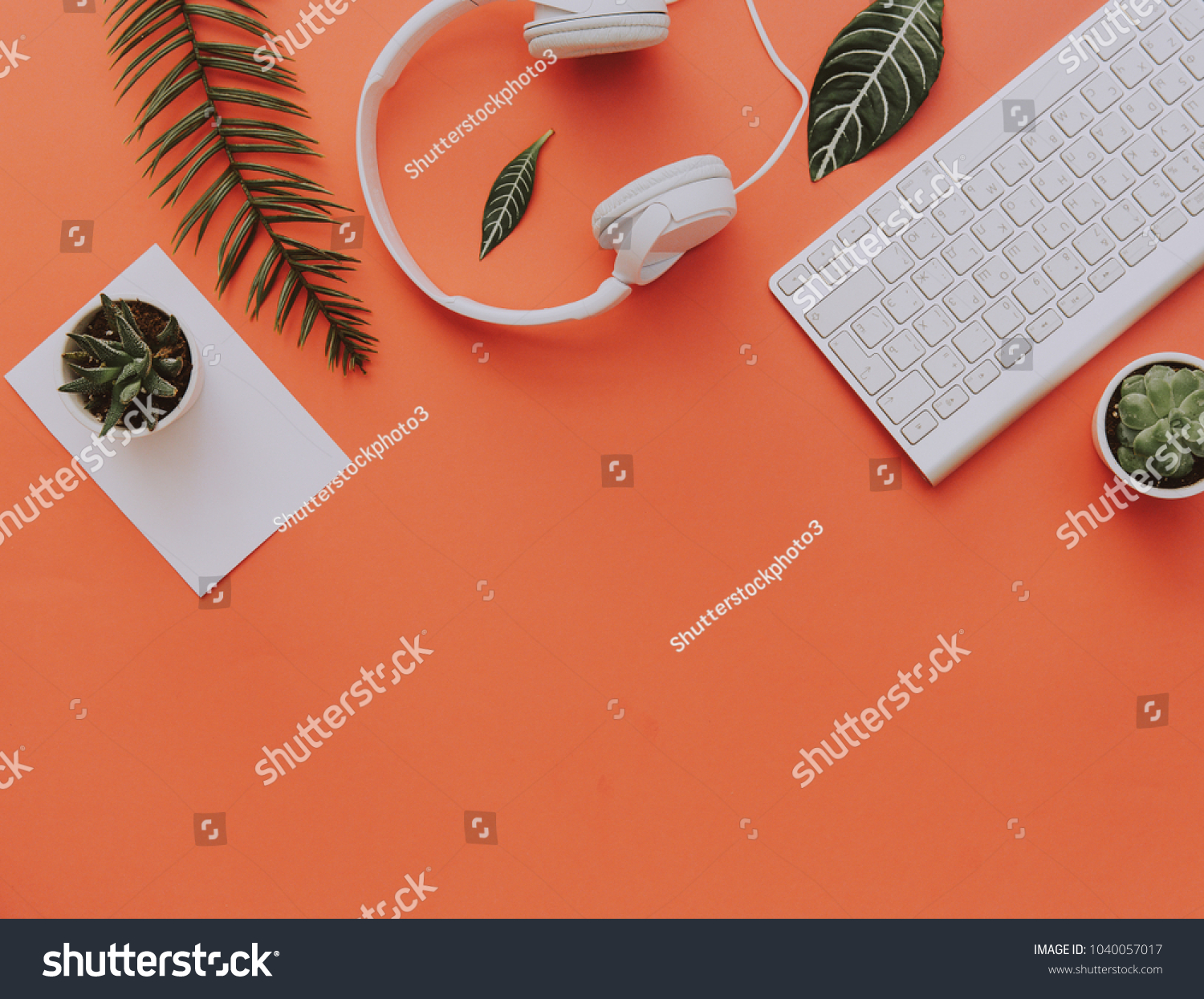 Creative flat lay of workspace desk, office stationery, keyboard, headphones and lifestyle objects on orange background with copy space #1040057017