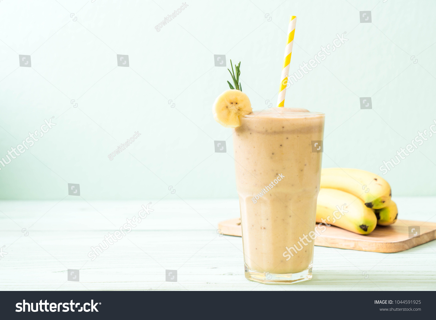 banana smoothies glass on wood table #1044591925