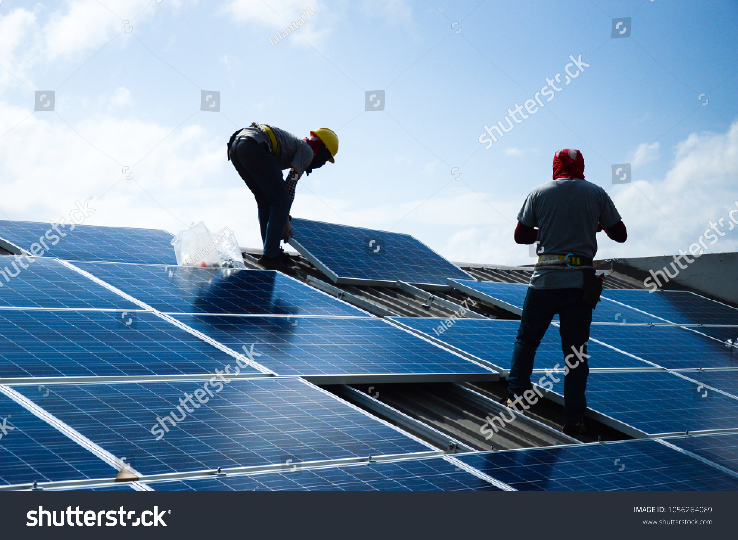 Installing a Solar Cell on a Roof #1056264089
