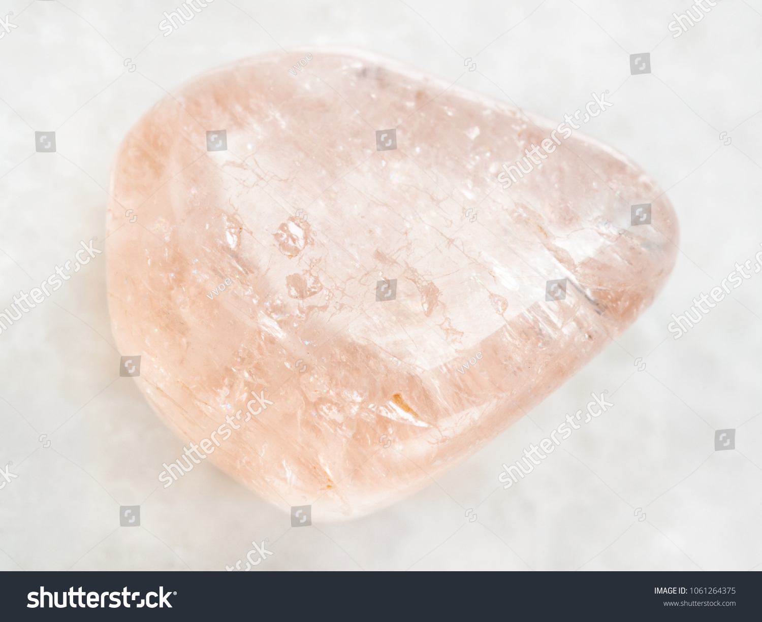 macro shooting of natural mineral rock specimen - morganite (pink beryl) gemstone on white marble background from Ural Mountains, Russia #1061264375