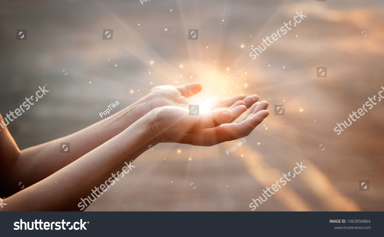 Woman hands praying for blessing from god on sunset background  #1063994864