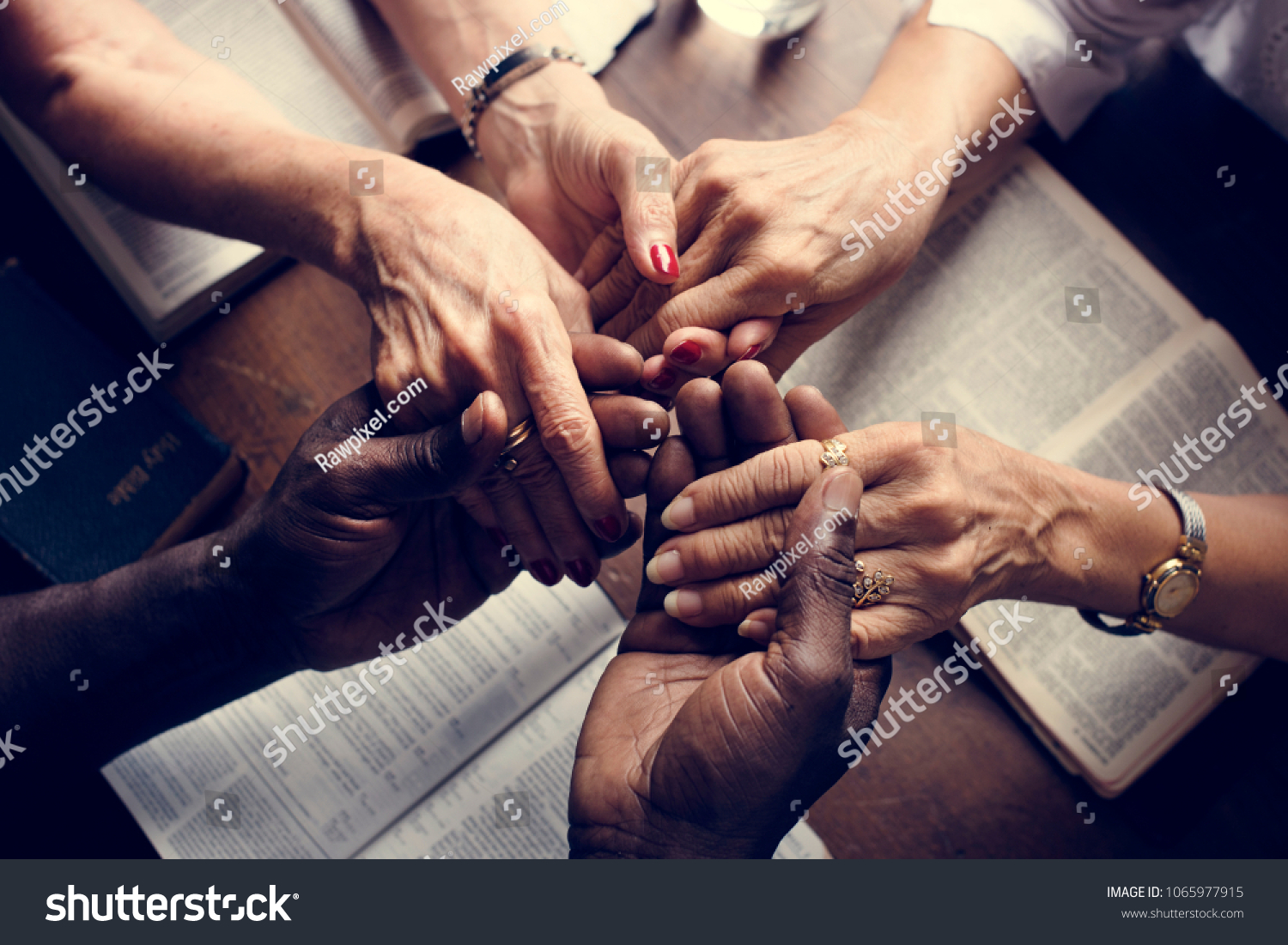 Group of people holding hands praying worship believe #1065977915