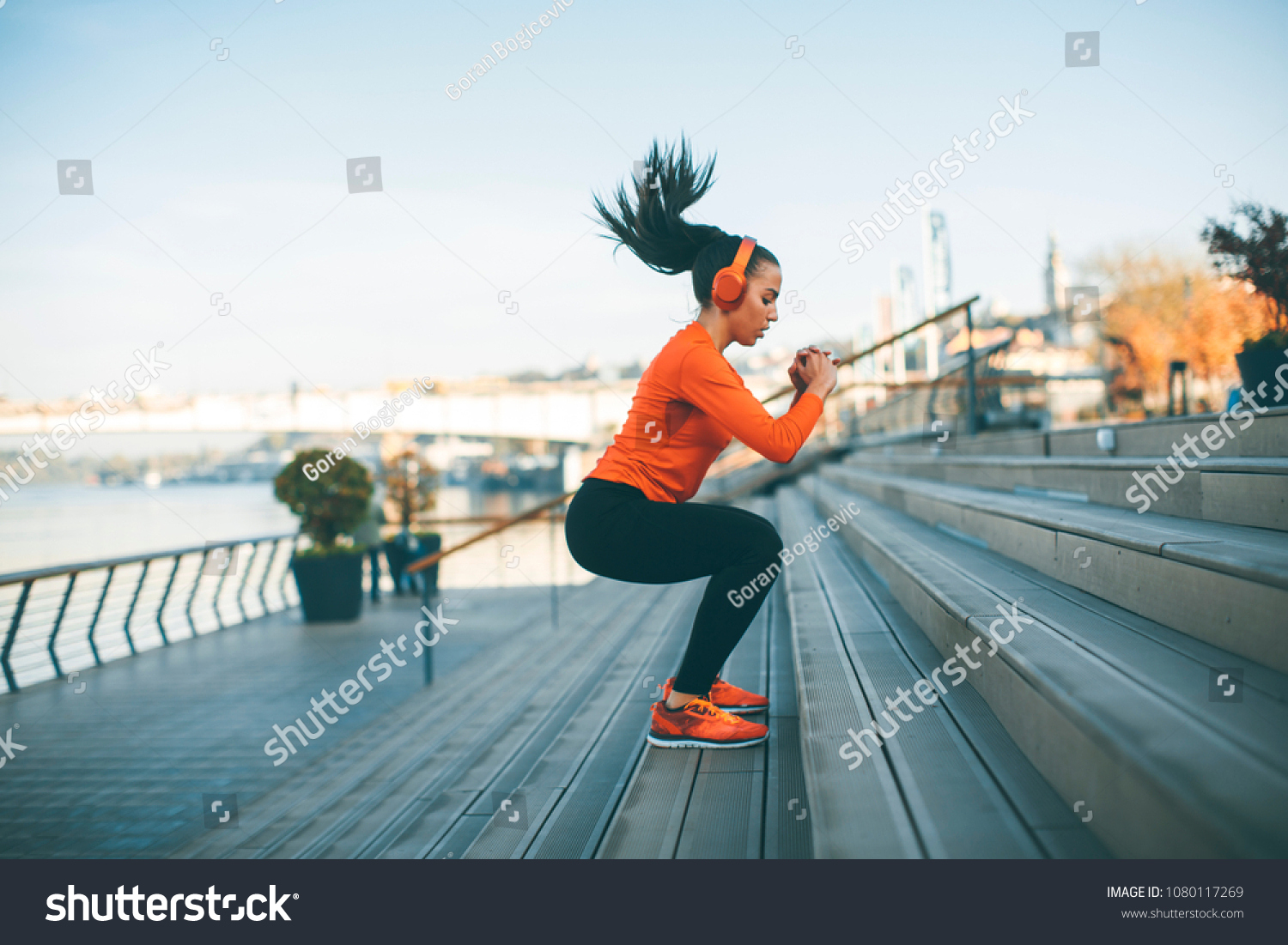 Fitness woman jumping outdoor in urban environment #1080117269