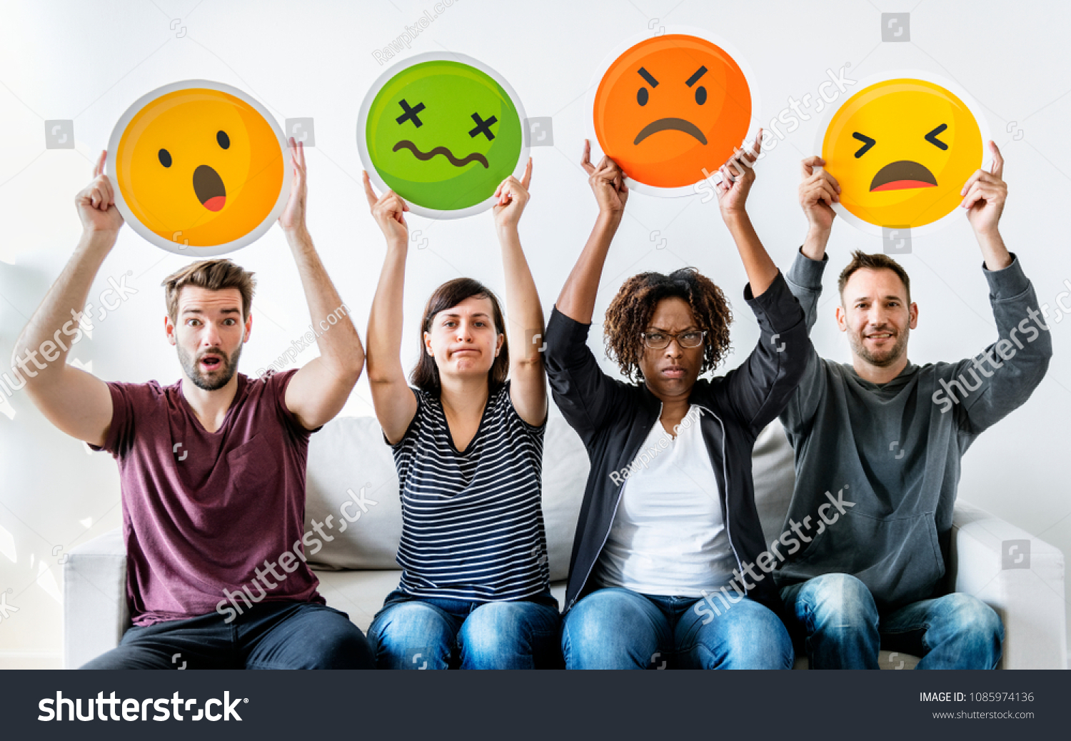 Diverse people holding emoticon #1085974136