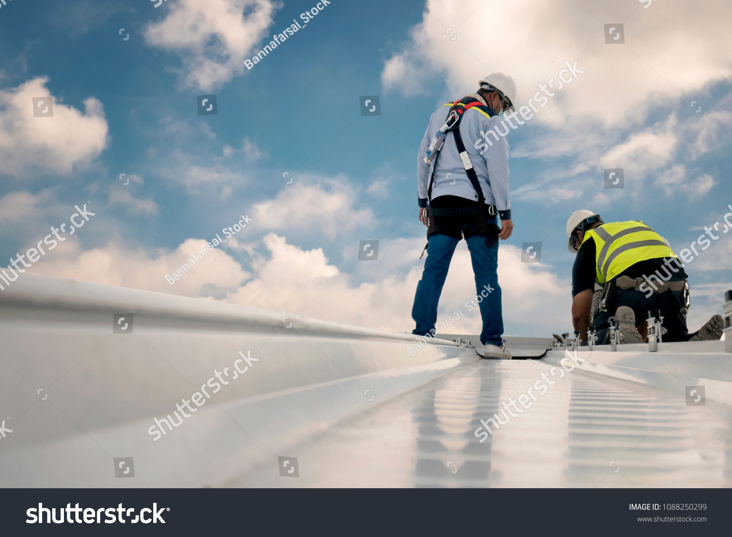 Construction engineer wear safety uniform inspection metal roofing work for roof industrial concept with copy space #1088250299