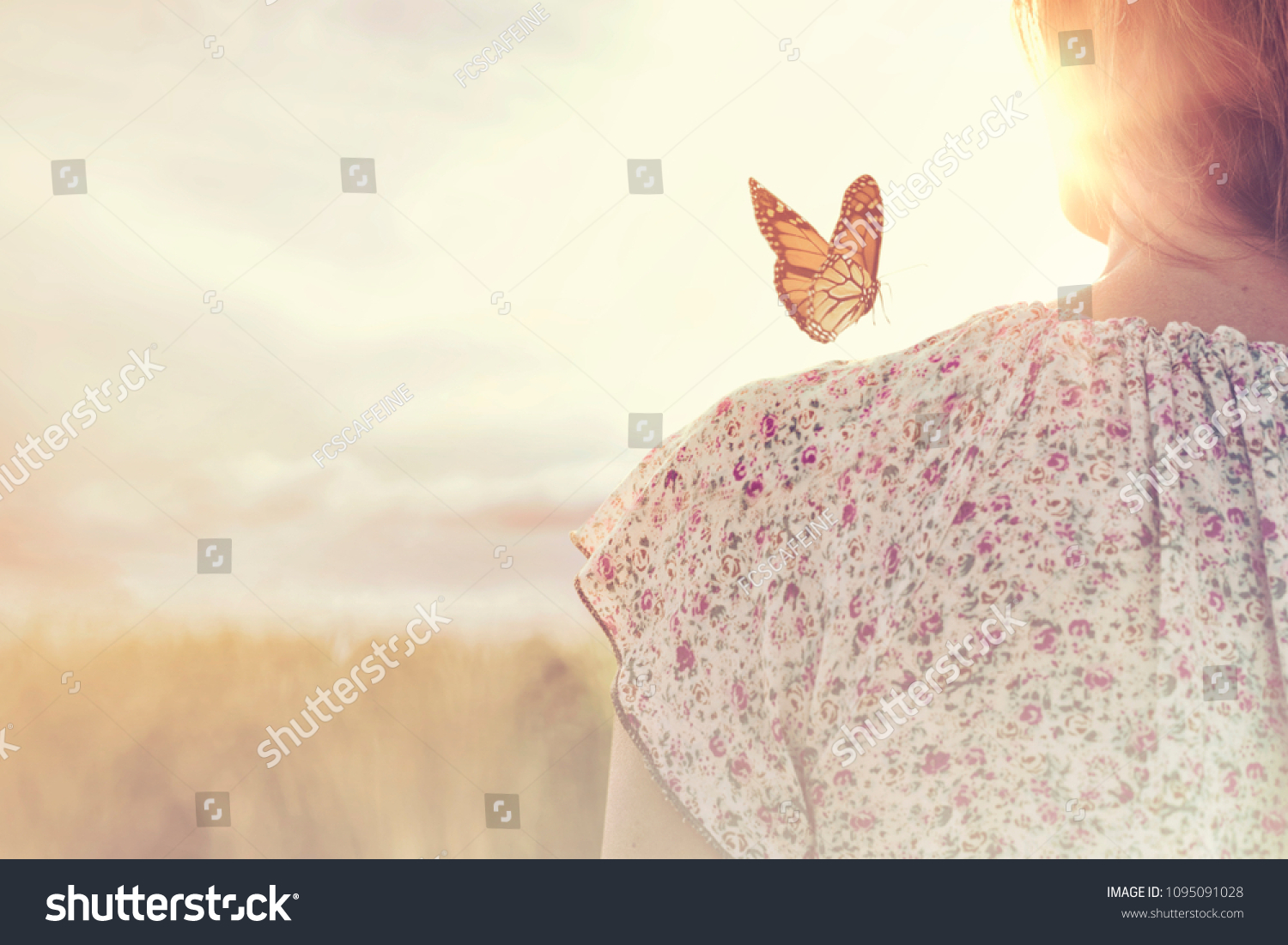 special moment of meeting between a butterfly and a girl in the middle of nature #1095091028