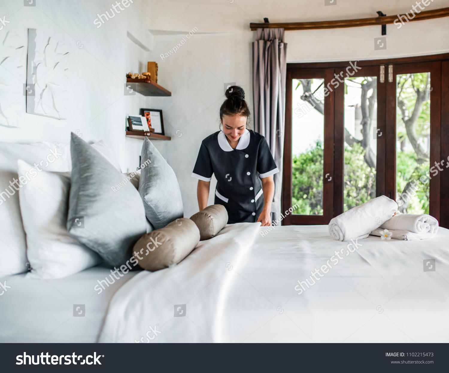 Housekeeper cleaning a hotel room #1102215473