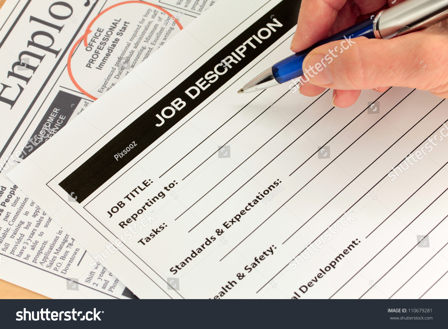 Job Description with Hand and Pen and Newspaper Ad #110679281