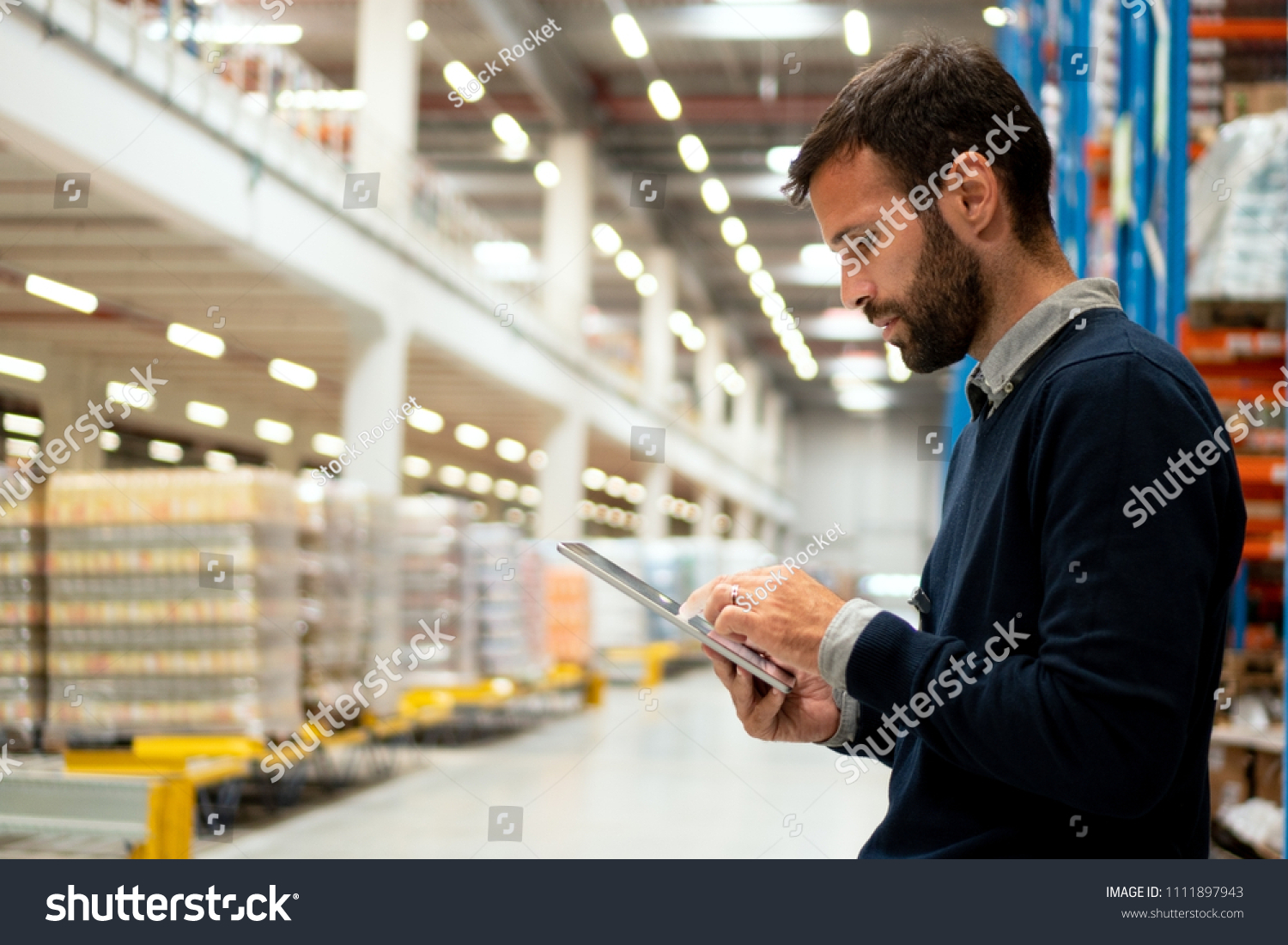 Manager holding digital tablet in warehouse #1111897943