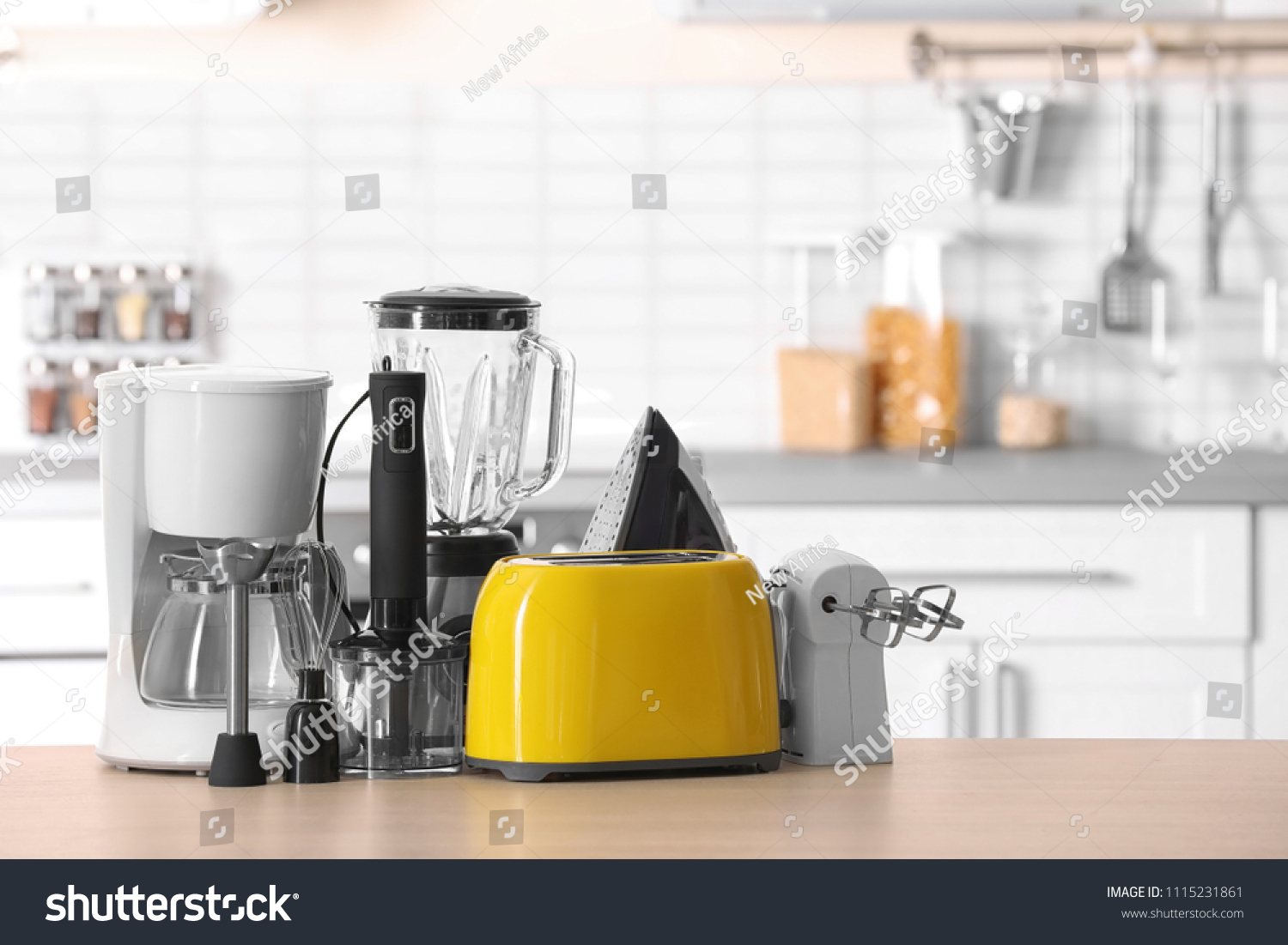 Household and kitchen appliances on table against blurred background #1115231861