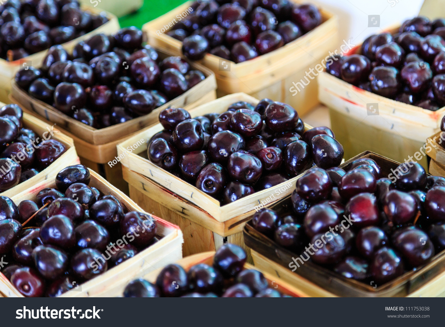 Cherries in wooden baskets at market #111753038