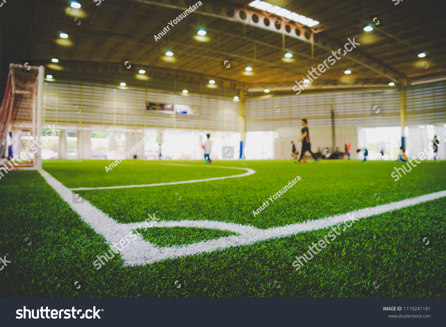 Corner Line of an indoor football soccer training field in Junior Soccer Academy school with blurred children and coach practicing on the background #1119241181
