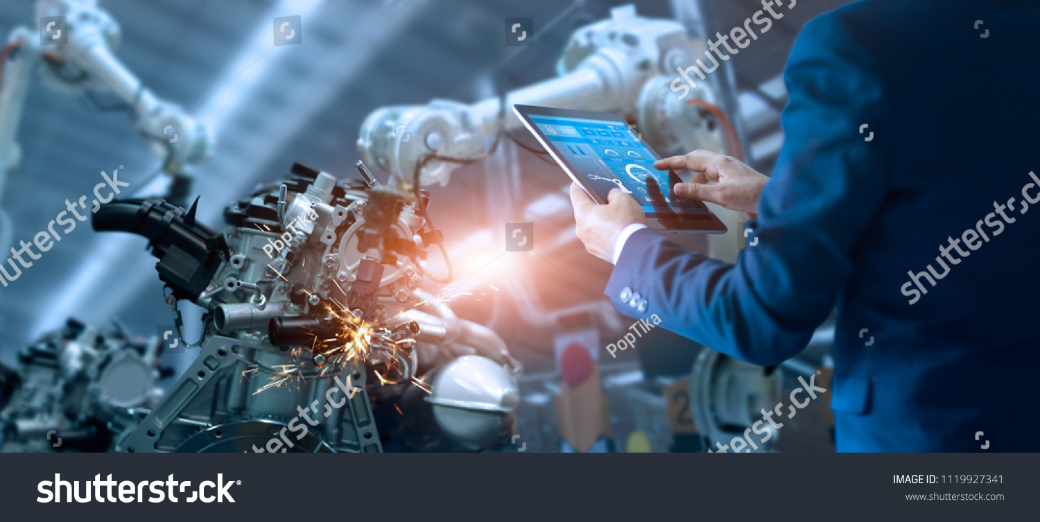 Manager engineer check and control automation robot arms machine in intelligent factory industrial on real time monitoring system software. Welding robotics and digital manufacturing operation.  #1119927341