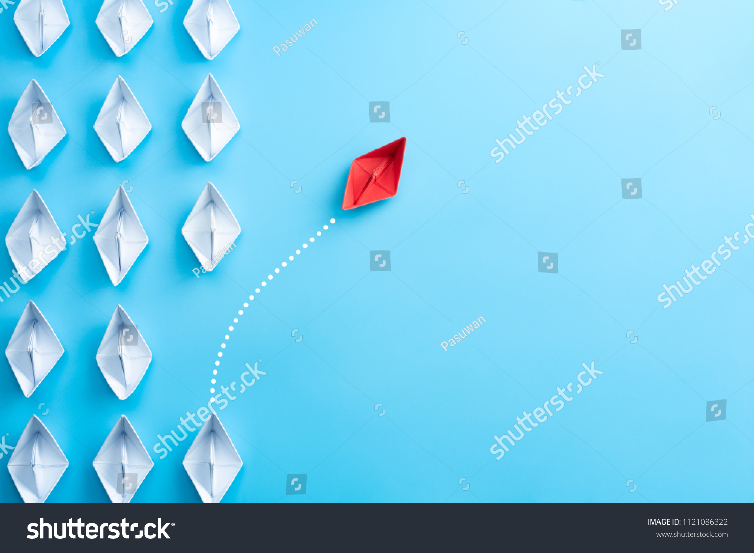 Group of white paper ship in one direction and one red paper ship pointing in different way on blue background. Business for innovative solution concept. #1121086322