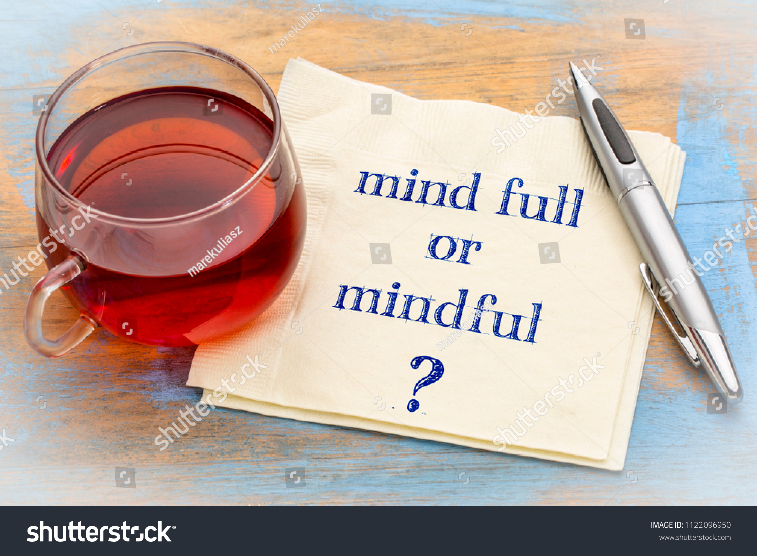 Mind full or mindful   Inspiraitonal handwriting on a napkin with a cup of tea. #1122096950