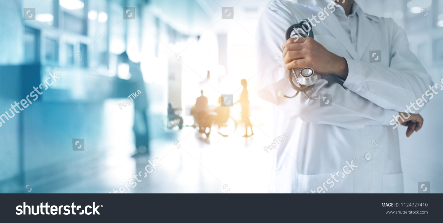 Healthcare and medical concept. Medicine doctor with stethoscope in hand and Patients come to the hospital background. #1124727410