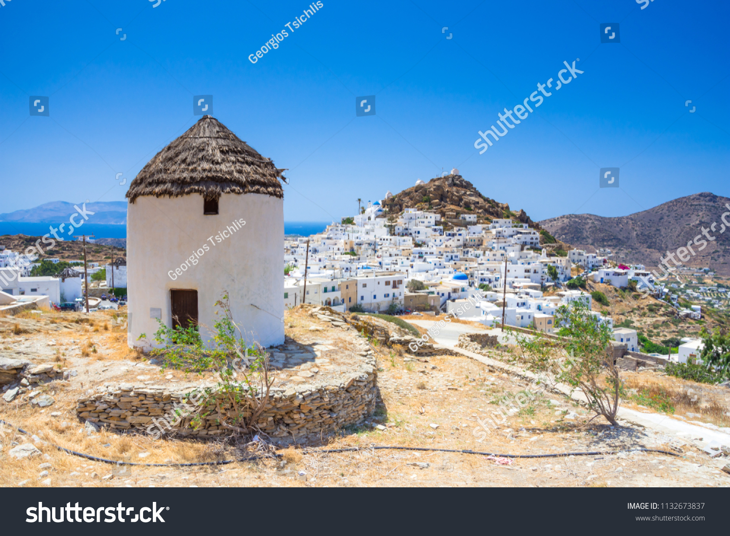 Iconic traditional wind mills in Ios island, Cyclades, Greece. #1132673837
