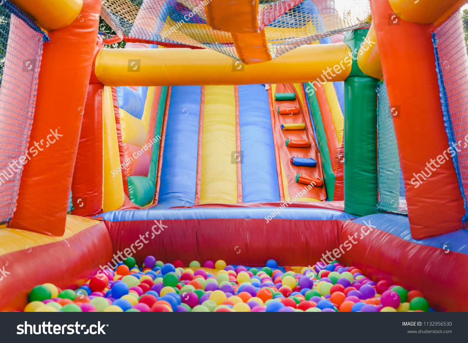 Inflatable castle full of colored balls for children to jump #1132956530