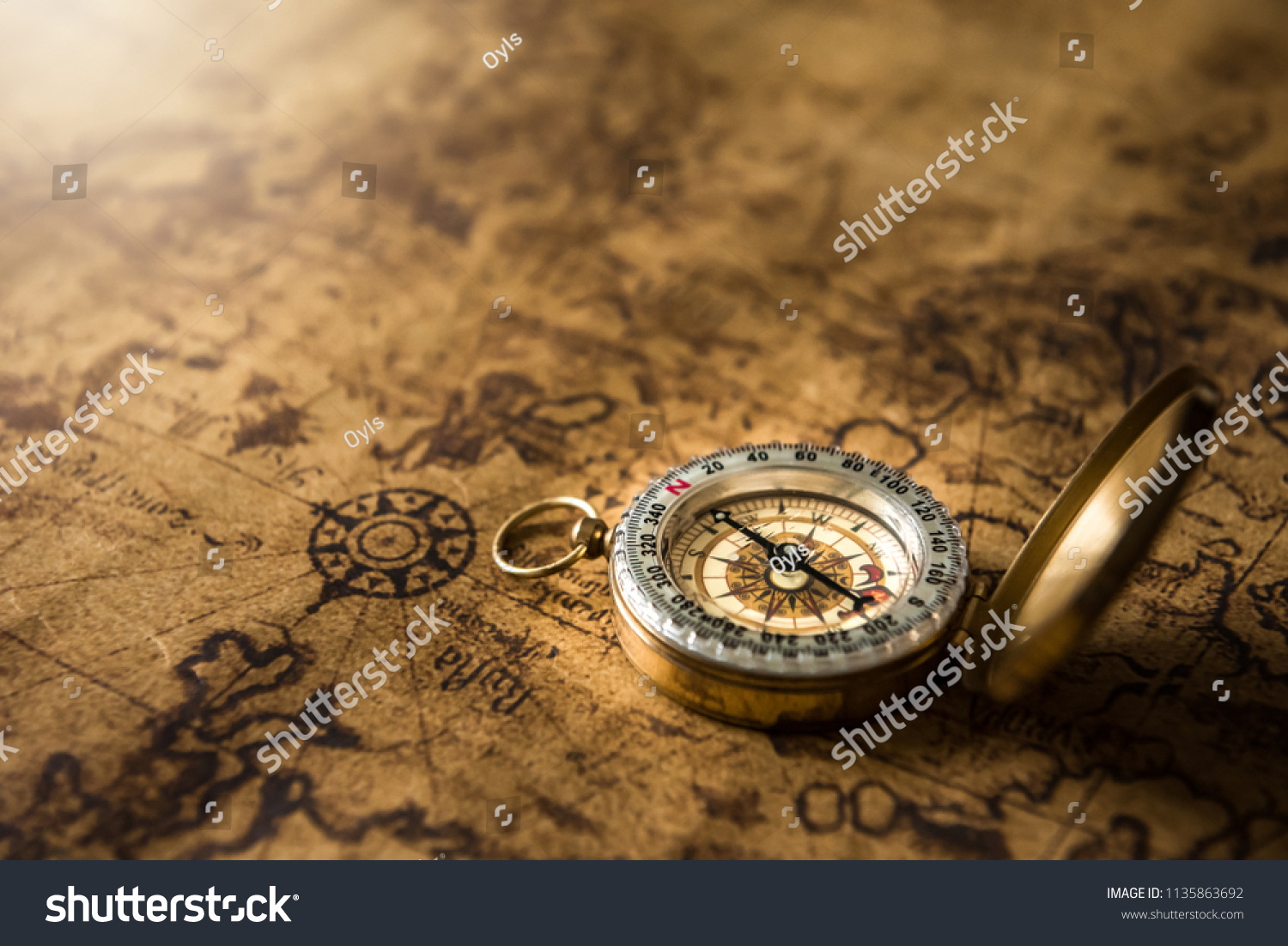 Old gold compass on ancient map background ,vintage tone with copy space for text. #1135863692
