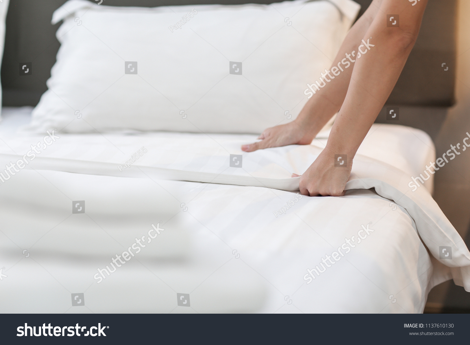 Hands Making Bed from Hotel Room Service #1137610130