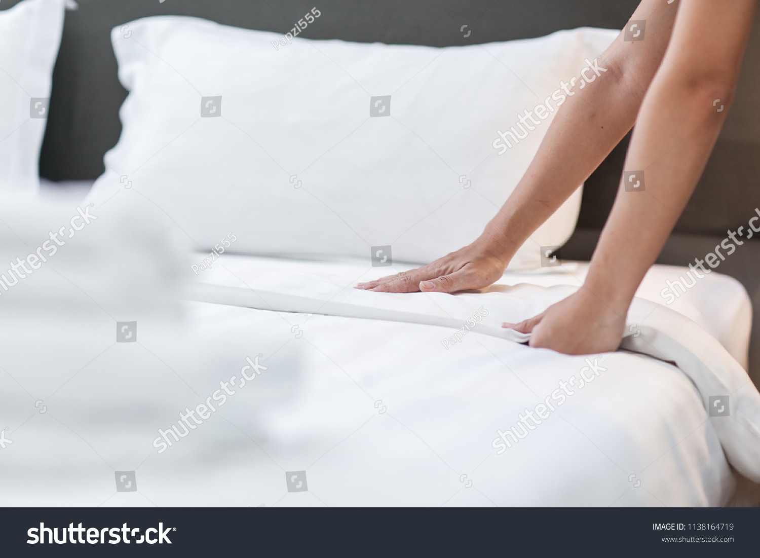 Hands Making Bed from Hotel Room Service #1138164719