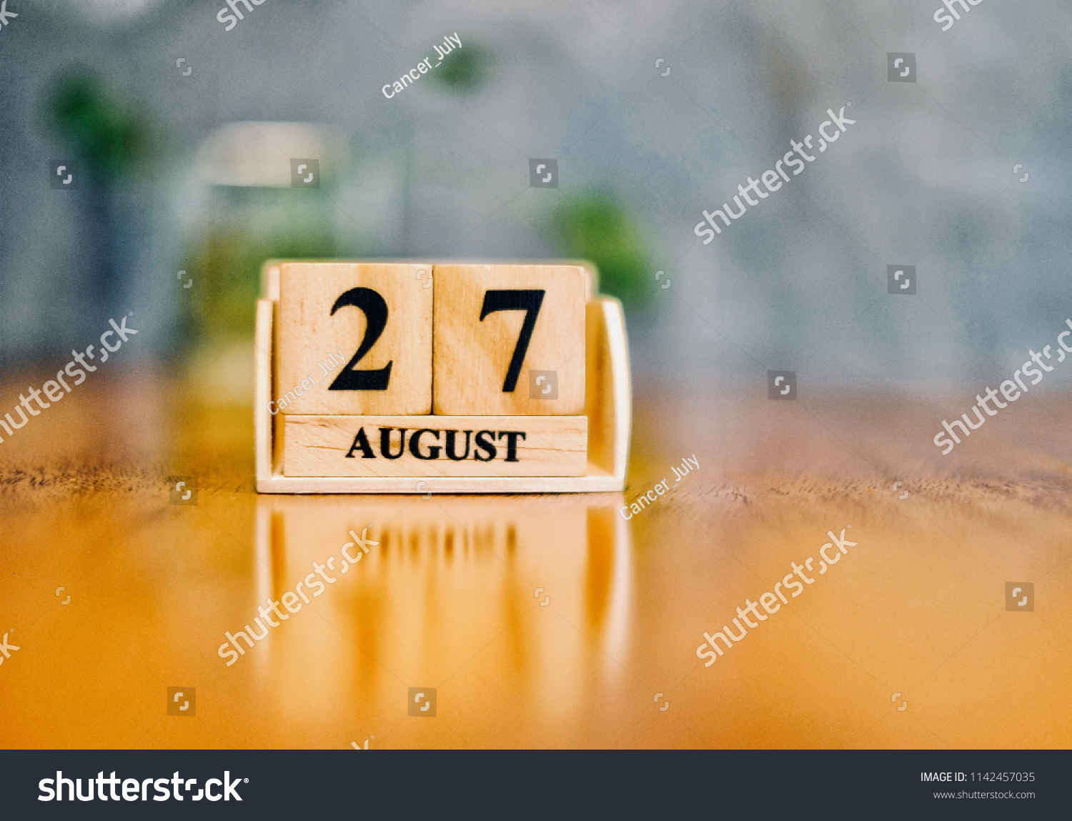 August 27th. Soft Selective focus on wooden block calendar on blurred wooden table and loft cement background with copy empty space for text. #1142457035