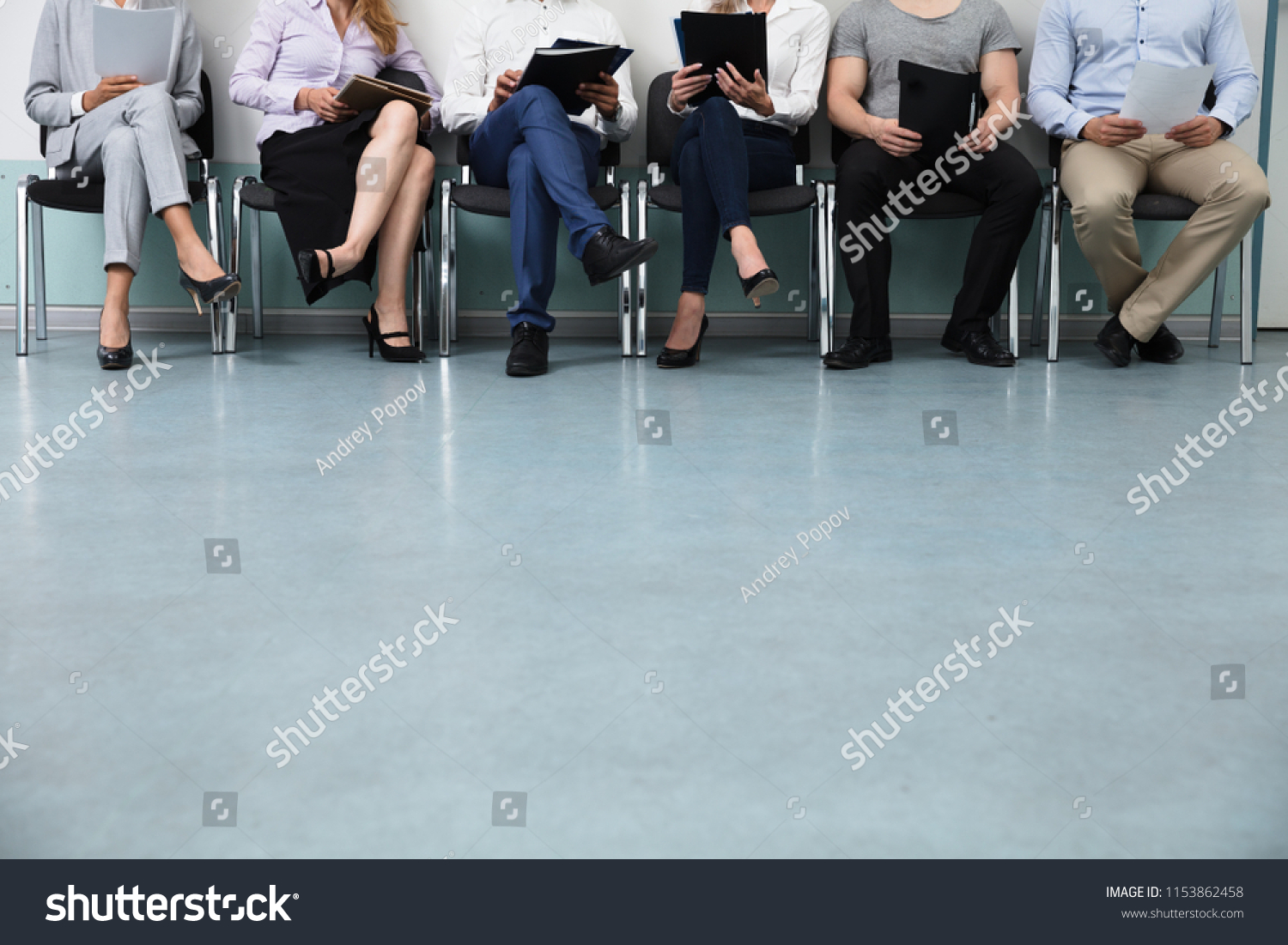 Row Of Candidates Sitting On Chair For Job Interview #1153862458