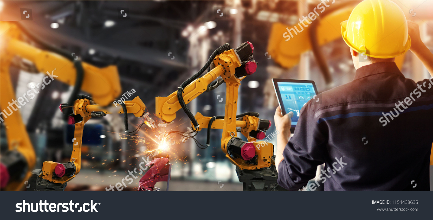 Engineer check and control welding robotics automatic arms machine in intelligent factory automotive industrial with monitoring system software. Digital manufacturing operation. Industry 4.0 #1154438635